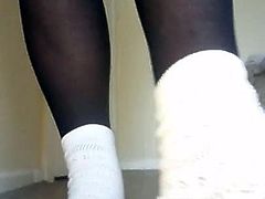 White socks worn over black tights with white trainers