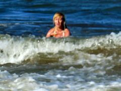 Blonde playing with the waves