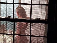 Voyeur catches girl naked through window
