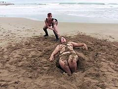 Mistress Kara starts her humiliating punishment on a deserted beach, but this is only the beginning... This fat red-haired woman will be buried in the sand, she will be whipped and humiliated and then taken to a bar, where strangers will fuck her...