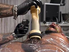 Ah, this is a beautiful sight for those who appreciate refined bdsm punishments! Micah's big black cock draws so much attention that his tormentor, Jason Collins, decides to start with it, using a special kinky device. Join to enjoy hot interracial gay bondage!