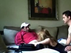 A blonde milf in sexy lingerie gets some hardcore double penetration from two guys on the sofa at home.