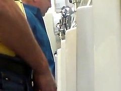 Cute daddy pissing at Urinal