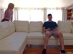 Watch this petite blonde teen Brit get all riled up in the living room while Josh is playing video games. While Josh wants to complete his game, Brit has other plans in mind, she whips out his big juicy dick and wraps her lips around it and takes it all the way down her throat.