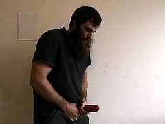 Man strokes his large cock dildo