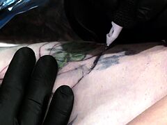 Marie Bossette gets a rose tattooed on her rib